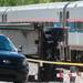 A passenger looks out at half of a semitrailer that sits next to an Amtrak train at North Maple Road and Huron River Drive in Ann Arbor Township after being struck by the train, Saturday, May 25.
Courtney Sacco I AnnArbor.com
